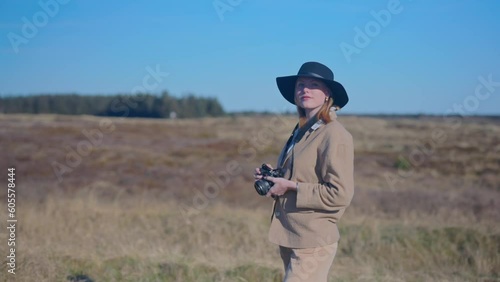 girl taking photo in a field