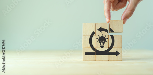 Creative idea, solution and innovation concept. Idea generation for business development. Wooden cube blocks with light bulb and cycle icons on clean background and copy space.