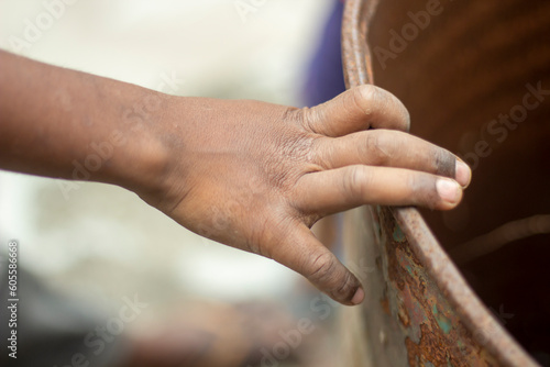 One hand holds an Iron tank and the background blur © Rokonuzzamnan