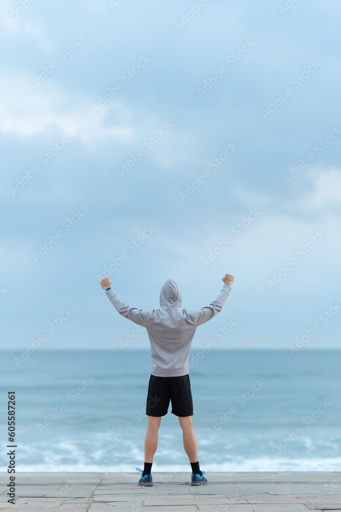 Man looking to the horizon and raising hands Man looking to the horizon and raising hands