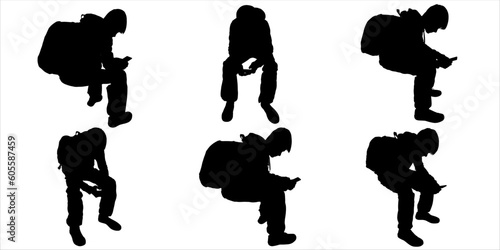 A young man with a backpack and a mobile phone in his hand. The teenager is sitting. Silhouette of a schoolboy with a backpack and a mobile phone. Set of black silhouettes on a white background