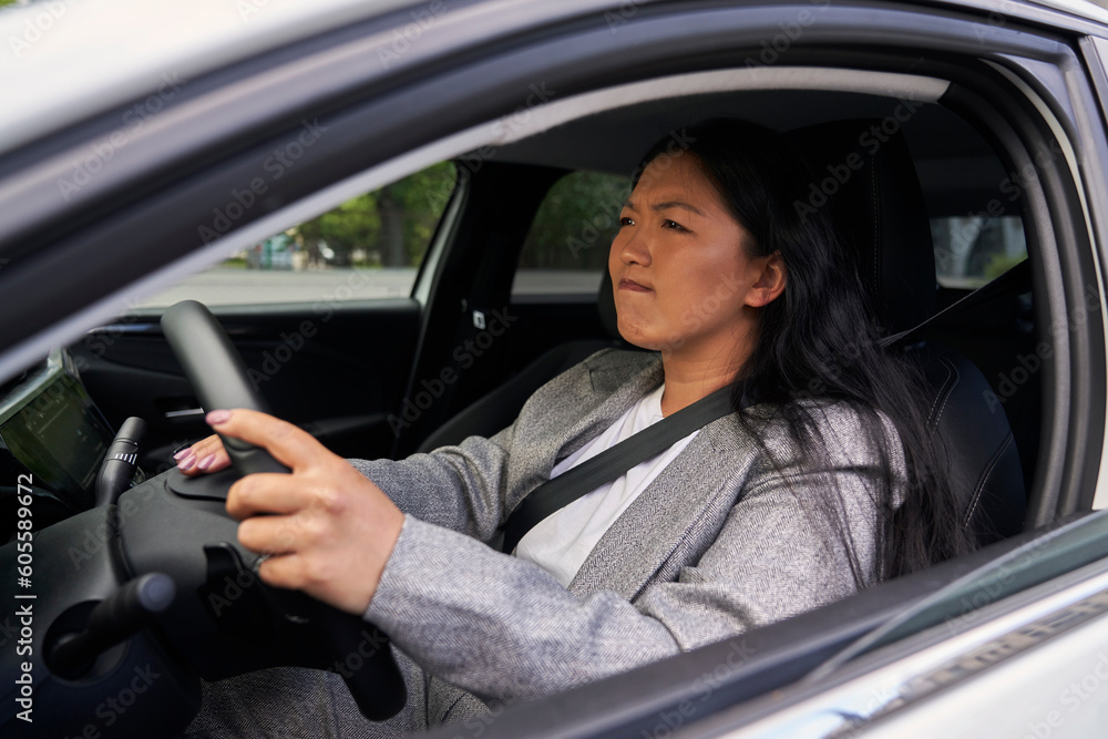 Frustrated Chinese woman using car horn on the street Frustrated Chinese woman using car horn on the street
