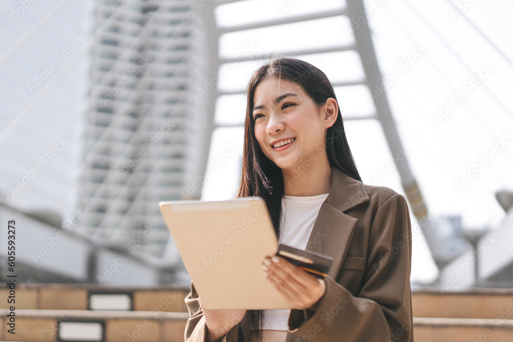 Happy smile young woman using creadit card and digital tablet for shopping online payment Happy smile young woman using creadit card and digital tablet for shopping online payment