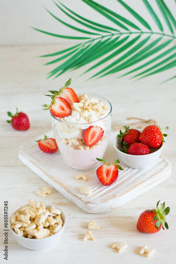 Dessert of cookies and whipped cream with strawberries in a glass Dessert of cookies and whipped cream with strawberries in a glass