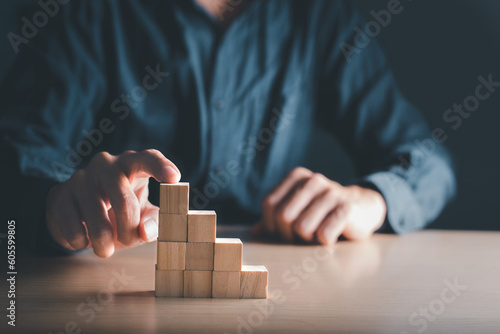 Wooden blocks with copy space show the steps. The development of a business
