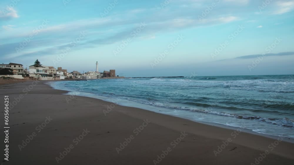 Distant lighthouse in Punta secca city on the ocean in Sicily