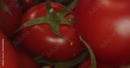 red tomatoes in wooden box and with laowa optics in the foreground in motion