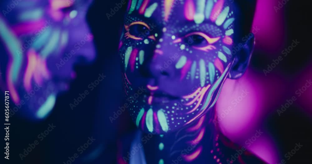 Young Sensual Model Poses with Grace and Poise, Her Vivid Body Paint Complementing Dark Abstract Background and Distorted Mirror Image, Resulting in a Radiant Fashionable Beauty Footage Young Sensual Model Poses with Grace and Poise, Her Vivid Body Paint Complementing Dark Abstract Background and Distorted Mirror Image, Resulting in a Radiant Fashionable Beauty Footage