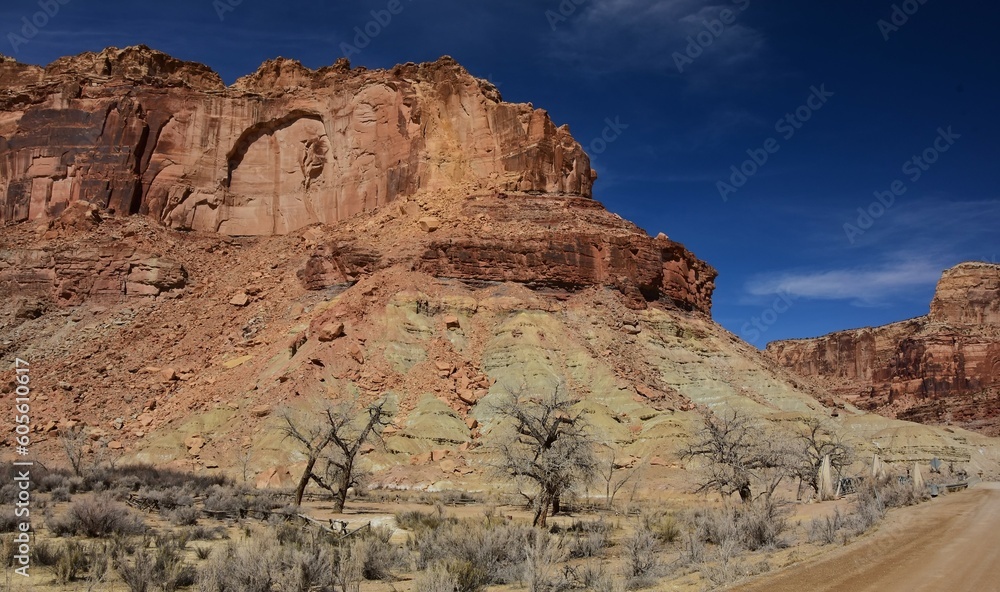 red rock  buttes and  the historic swinging bridge on a sunny winter day   in  san rafael river canyon along the buckhorn draw scenic backway in the northern san rafael swell near green river,  utah 