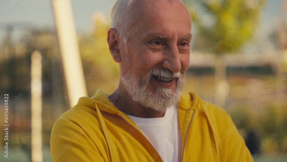 Bearded man in his 60s sincerely smiling, pleased with outdoor workout, wellness Bearded man in his 60s sincerely smiling, pleased with outdoor workout, wellness