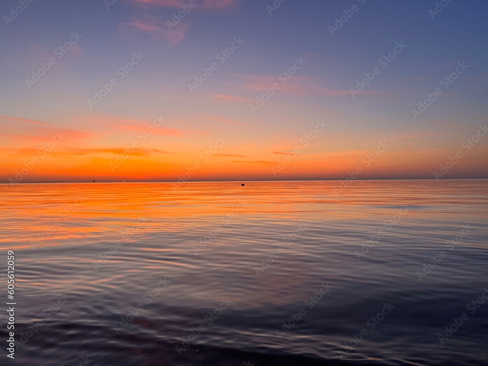 Obraz premium Seascape after the sunset, orange sunset sea horizon, twilights sea view background