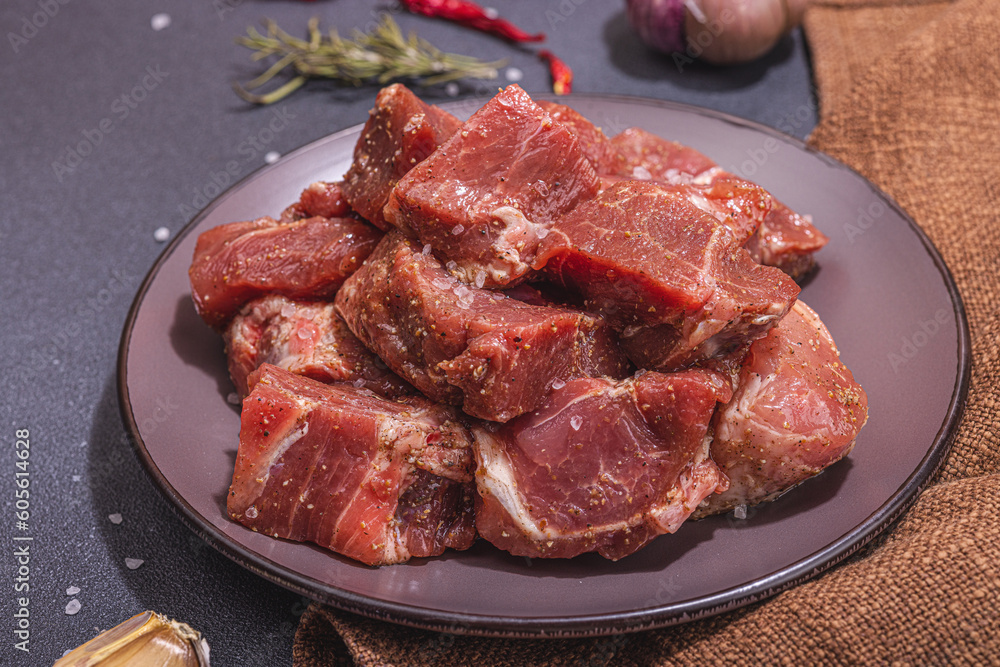 Raw pork loin pieces with ground spices. Marinated meat cuts, ingredient for cooking healthy food Raw pork loin pieces with ground spices. Marinated meat cuts, ingredient for cooking healthy food