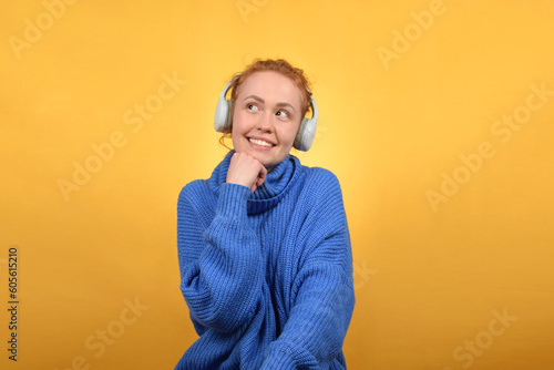 cute happy woman enjoying music in headphones