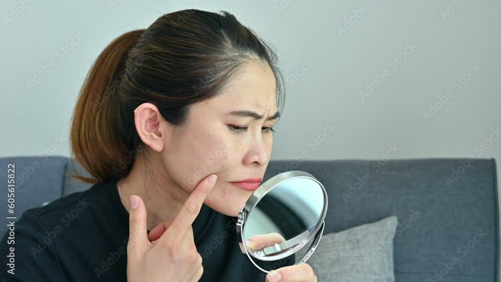 Asian woman worried about her face when she saw acne and wrinkled occur on her face. Asian woman worried about her face when she saw acne and wrinkled occur on her face.