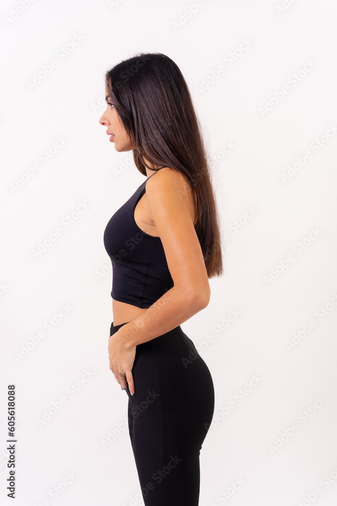 Person brunette woman in casting photos on a white background. Profile portrait looking dressed in black Person brunette woman in casting photos on a white background. Profile portrait looking dressed in black