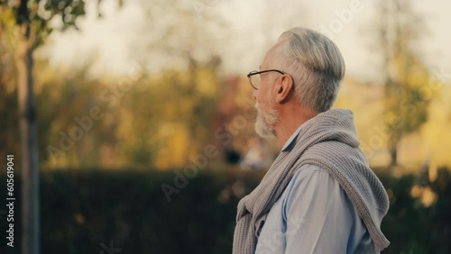 Wallpaper Mural Relaxed senior man in glasses walking in city park, enjoying nature and rest Torontodigital.ca