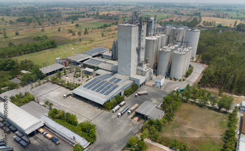 Aerial view of animal feed factory. Agricultural silos, grain storage silos, and solar panel on roofs of industrial plants. Industrial landscape. Agriculture industry. Factory with sustainable energy. photo