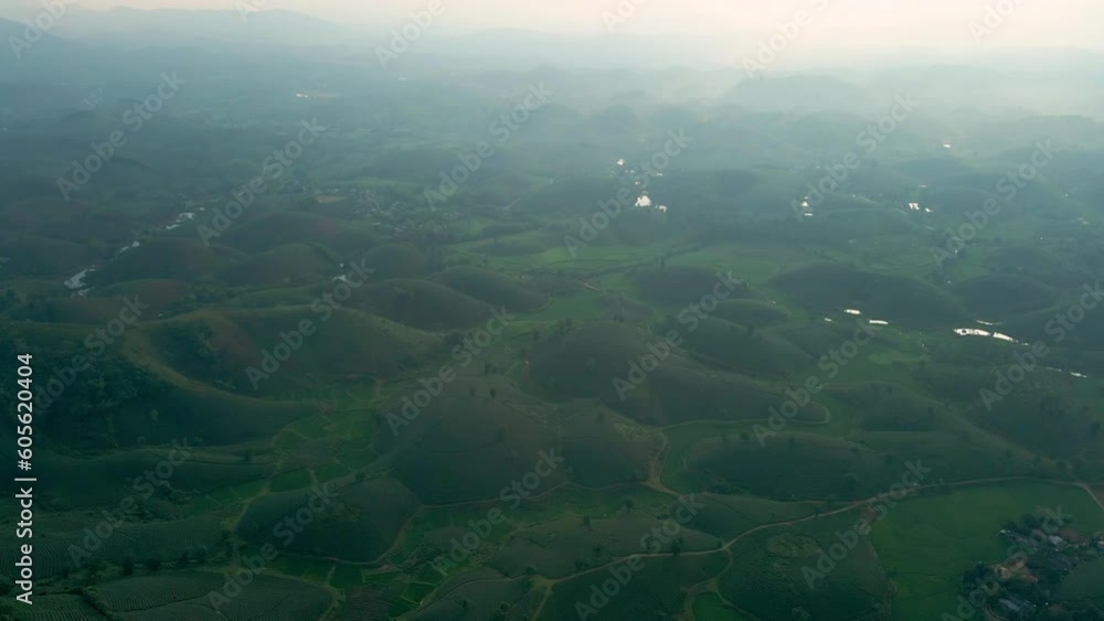 Long Cốc's surreal landscape VN. Aerial gentle pull back shot of tea hills rising out of of the misty valley below creating a mystical landscape. Long Cốc's surreal landscape VN. Aerial gentle pull back shot of tea hills rising out of of the misty valley below creating a mystical landscape.