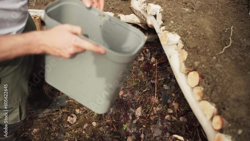 Wallpaper Mural Watering Plant Debris Under Raised Garden Bed With Soil. closeup Torontodigital.ca