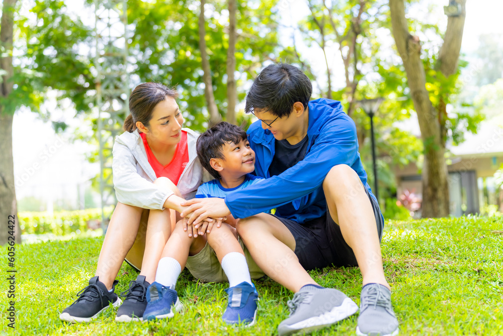 Happy Asian parent and little kids enjoy and fun outdoor lifestyle on summer vacation. Father, mother and child playing and relaxing together at park. Family relationship and health care concept. Happy Asian parent and little kids enjoy and fun outdoor lifestyle on summer vacation. Father, mother and child playing and relaxing together at park. Family relationship and health care concept.