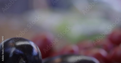 
Assorted fruit, vegetables and fish in wooden baskets at village market