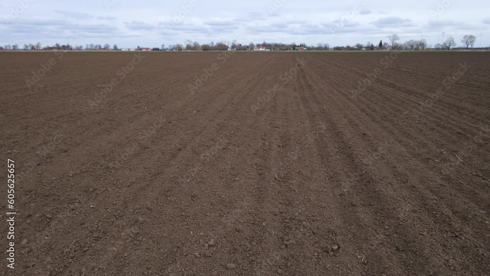 Fertility empty pure soil prepared for seeding crops in agricultural field after ploughing cultivation. Work in agronomic farm for making business and production organic eco bio food Fertility empty pure soil prepared for seeding crops in agricultural field after ploughing cultivation. Work in agronomic farm for making business and production organic eco bio food