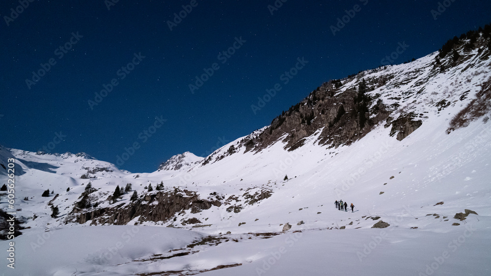 Φωτογραφία Skiers touring at night in the French alps in winter under the fullmoon light