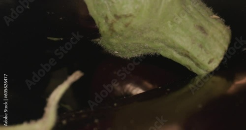 dark eggplant in wooden box and with laowa optics in the foreground in motion