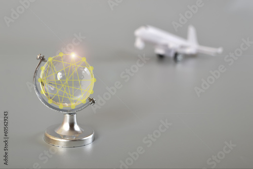 Airplane and crystal globe on grey background.Travel concept. Booking service or travel agency sign. Air transportation.