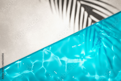Luxury swimming pool and palm shadow in water top view. Summer tropical background for product placement podium mockup. photo