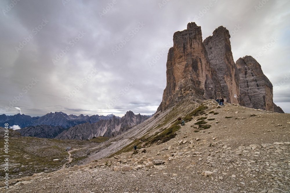 Group of tourists hiking in the Dolomites Alps, Italy