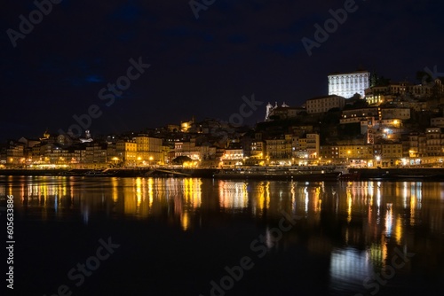 Low-angle view of modern buildings near the water at night in Oporto, Portugal