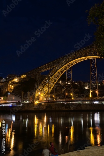 Vertical shot of a beautiful bridge above the water in Oporto, Portugal © Saltacekias/Wirestock Creators