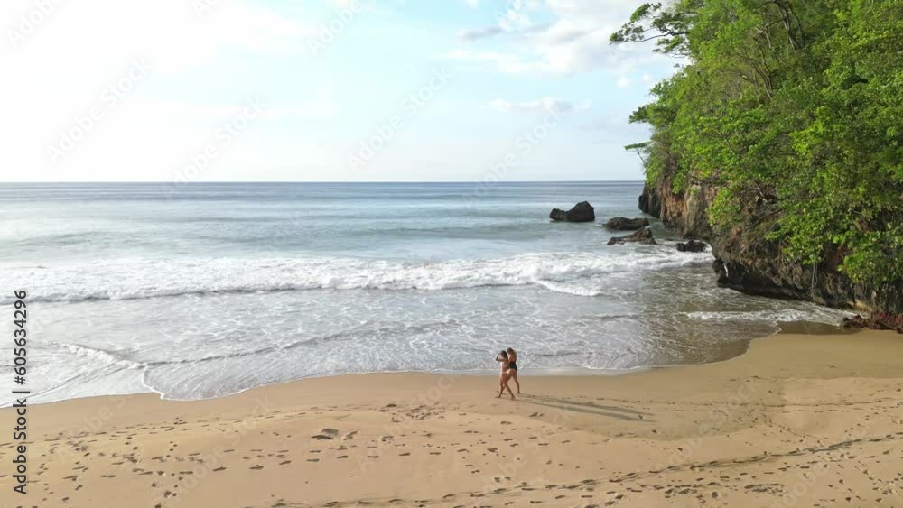 Two Girls walking on the beach in El Valle, Samana, Dominican Republic Two Girls walking on the beach in El Valle, Samana, Dominican Republic