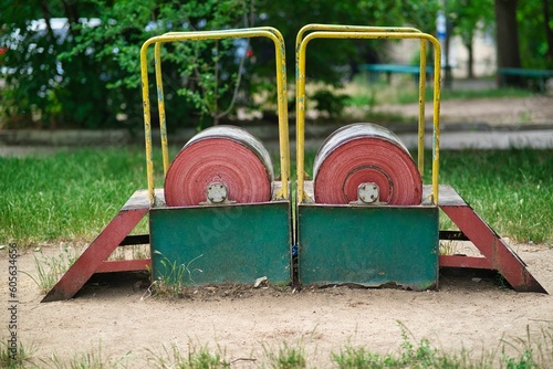 Wheels with metal handrails on an old Soviet-era playground in Tiraspol, Moldova.