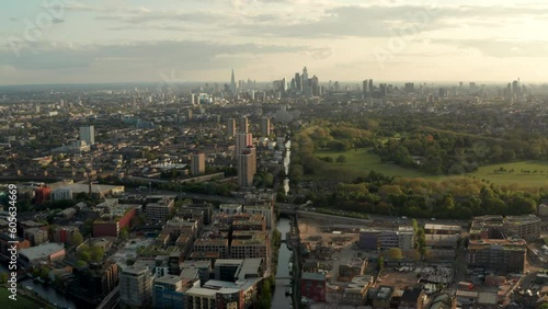 Dolly back aerial shot over Hertford union canal and Victoria Park with central London skyline photo