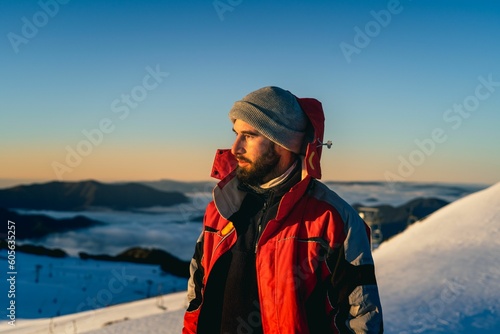 Closeup of a standing man at the mountain in winter looking aside