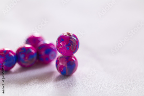 Pink and blue double beads on a white background