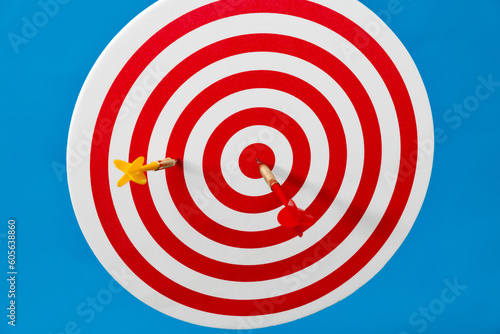 Target with darts on blue background