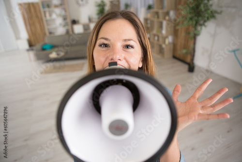 womans face woman behind a megaphone loud speaker photo