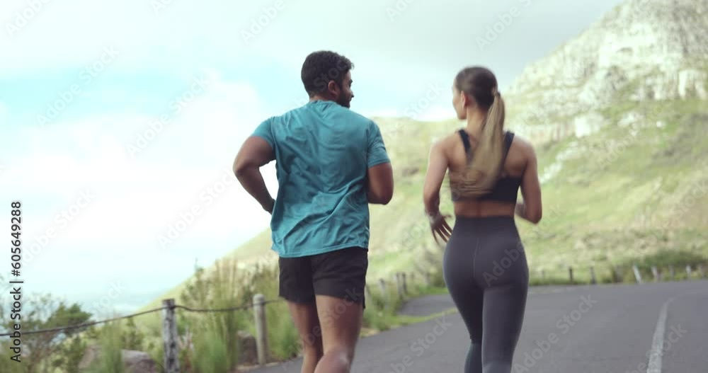 Fitness, running and couple workout on a mountain road for exercise and partner run. Outdoor, cardio and woman runner with a man back with marathon jog and speed movement on a street for sports Fitness, running and couple workout on a mountain road for exercise and partner run. Outdoor, cardio and woman runner with a man back with marathon jog and speed movement on a street for sports