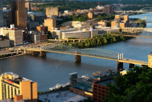 Bird's-eye view of buildings and bridges of a city by a river © Kyle Davidson/Wirestock Creators