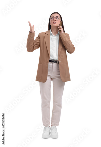 Beautiful businesswoman talking on smartphone against white background