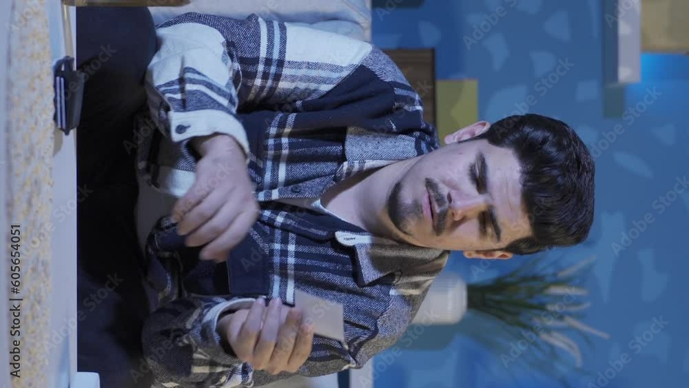 Vertical Video of The man looking at the photo cries and drinks alcohol. Vertical Video of The man looking at the photo cries and drinks alcohol.