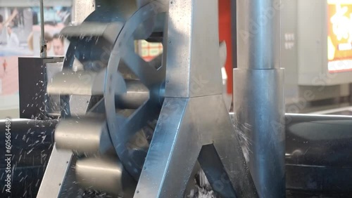 Footage of Metal water turbine slow spinning to generate free and green electricity
