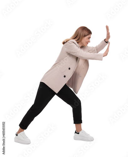 Beautiful businesswoman pushing something on white background photo