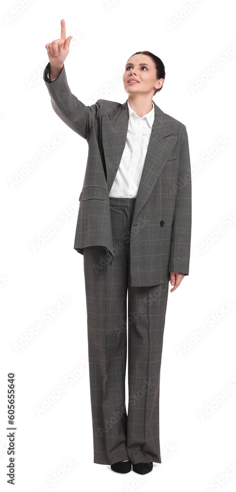 Beautiful businesswoman in suit pointing at something on white background Beautiful businesswoman in suit pointing at something on white background