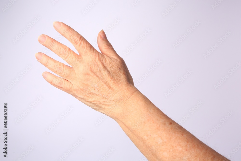 Closeup view of woman's hand with aging skin on white background Closeup view of woman's hand with aging skin on white background