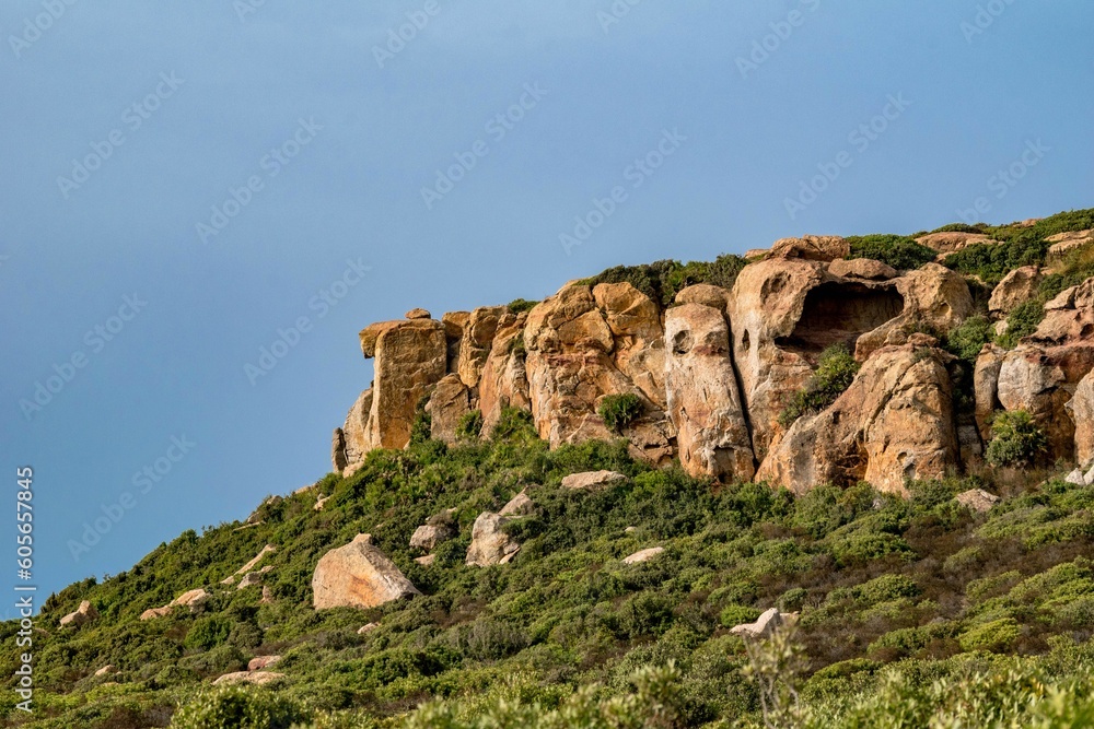 Low angle shot of a rocky cliff over a seashore in Kef Abbed, Tunisia