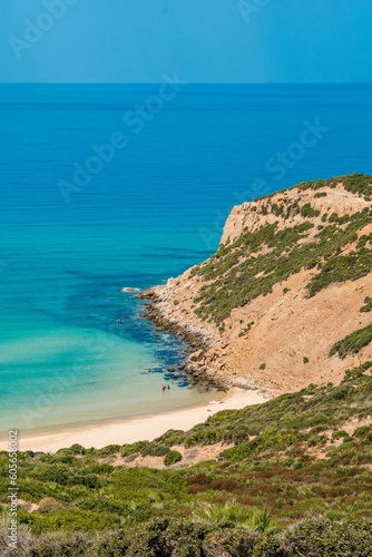 Fototapeta Naklejka Na Ścianę i Meble -  Vertical aerial view of a beautiful seashore with a rocky cliff in Kef Abbed, Tunisia